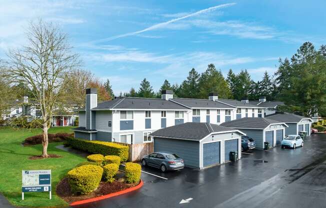 a view of the exterior of a building with cars parked in a parking lot