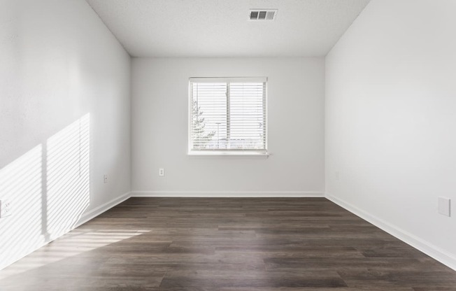 an empty bedroom with white walls and a window in Greenwood, Indiana