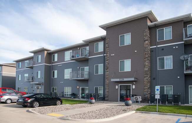 Exterior The Gardens Apartments Entrance and Parking Lot