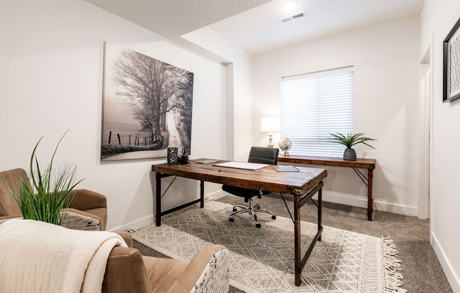 a home office with a desk and a window