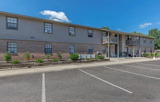 an empty parking lot in front of a house