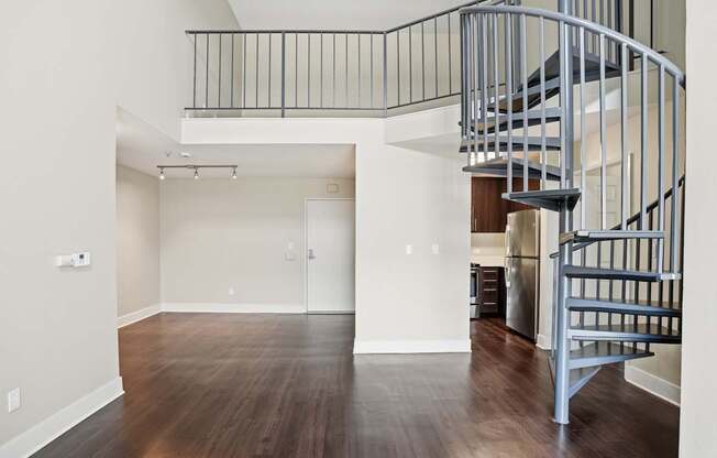 A large open living room with a spiral staircase.
