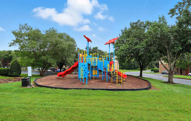 A playground with a blue and yellow slide.