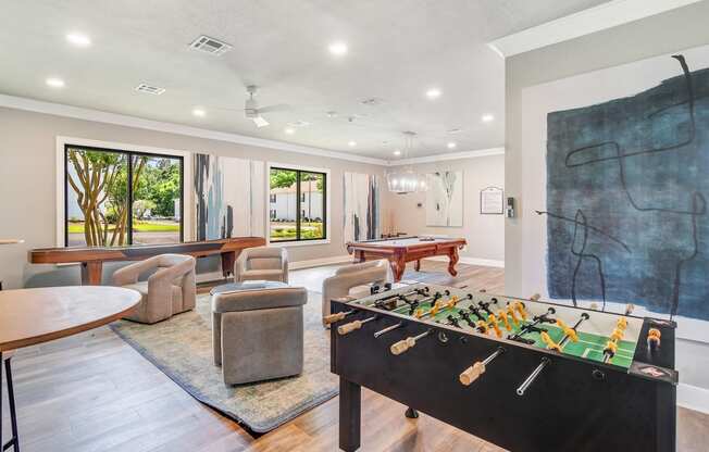 a game room with a foosball table and a pool table at The Vineyard of Olive Branch Apartment Homes in Olive Branch, MS 38654