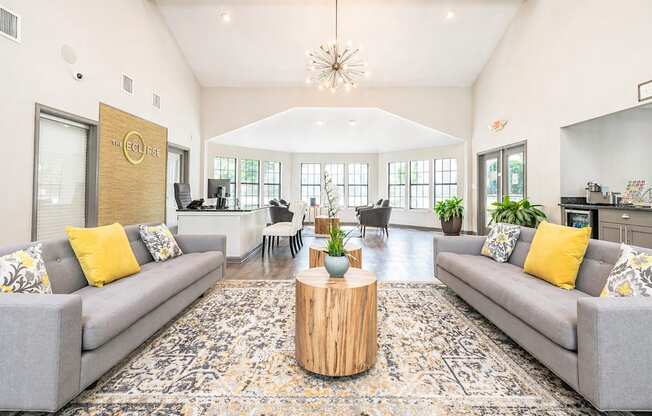 A living room with grey couches and a wooden coffee table.