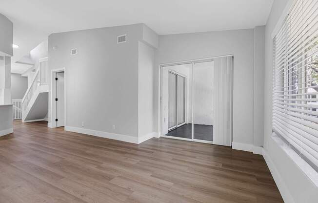 A room with wooden floors and white walls.