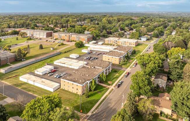 an aerial view of a campus with buildings and a road