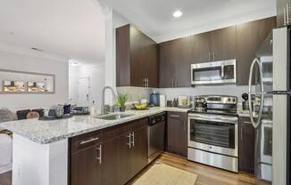 a modern kitchen with stainless steel appliances and marble counter tops
