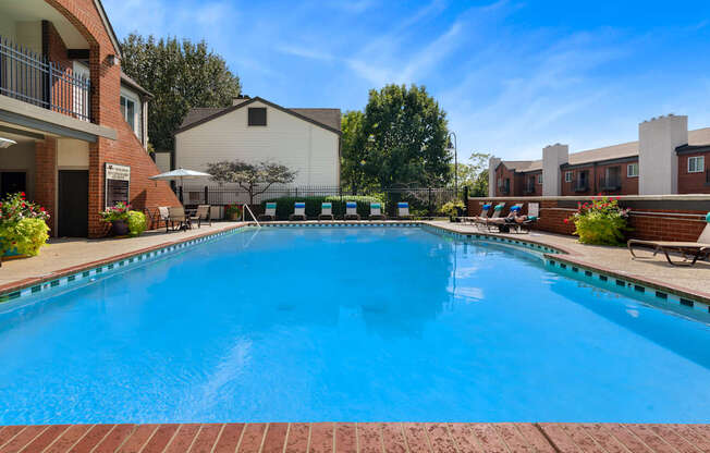 A large blue swimming pool in front of a building.