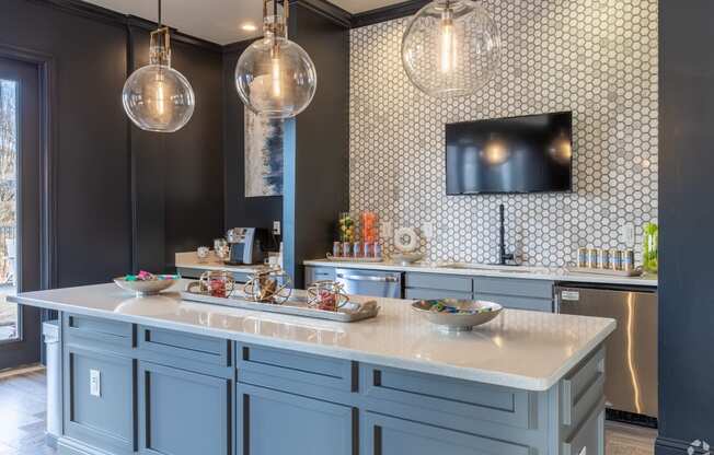 a kitchen with blue cabinets and a counter top and a tv