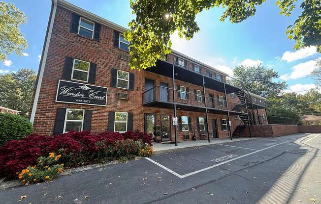 A building with a sign that says "Woodlawn Court" is shown.
