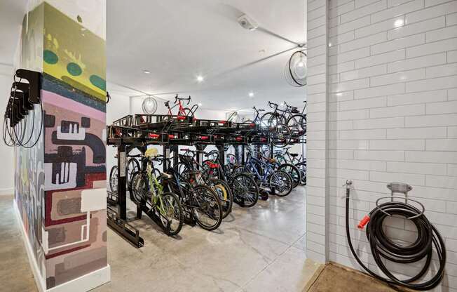 a group of bikes parked in a room with a rack of bikes at Link Apartments® Calyx, Chapel Hill, NC