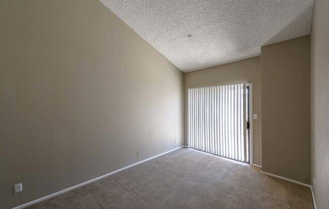 an empty living room with a sliding glass door