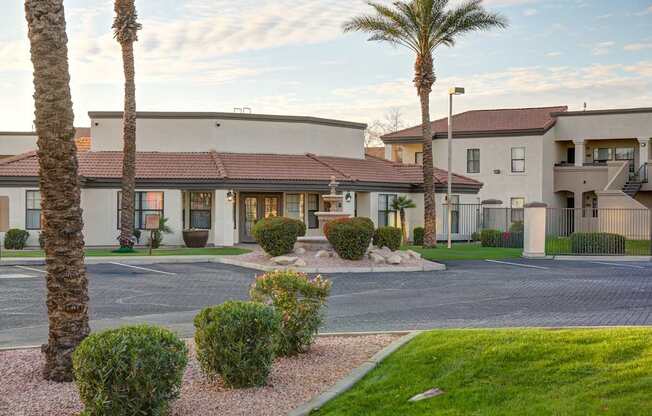 A residential area with a building and palm trees.