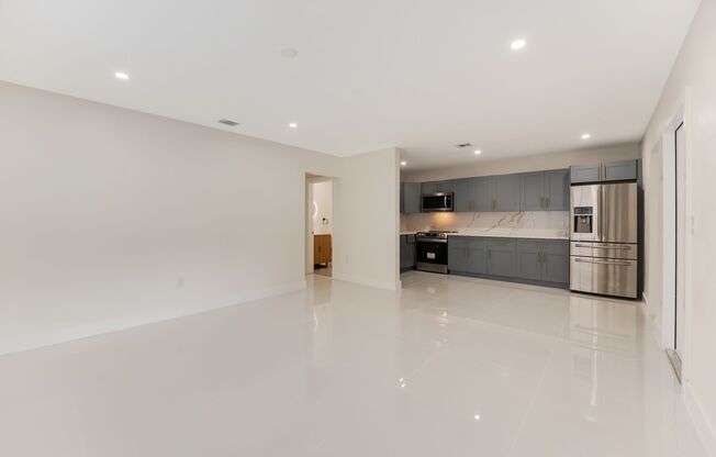 Fully renovated stylish 3 bed 2 bath home featuring a luxury kitchen, modern appliances on a fenced lot with parking!