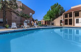 the community pool with green trees