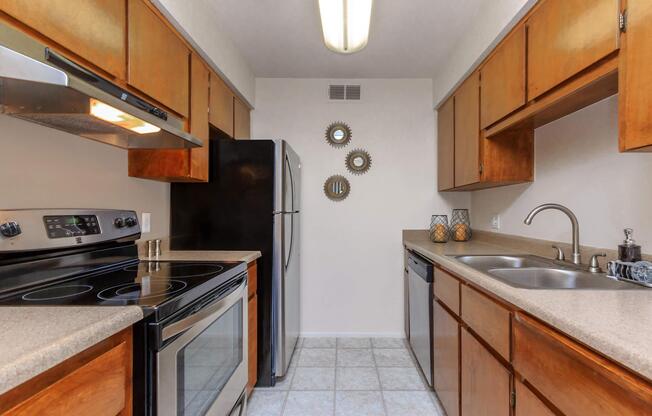 a modern kitchen with stainless steel appliances and wooden cabinets