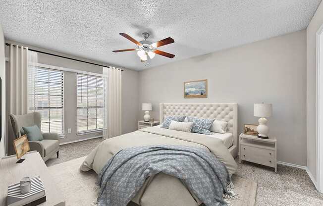 a bedroom with a large bed and a ceiling fan