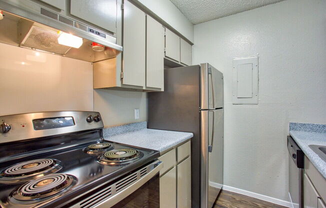 a kitchen with stainless steel appliances and a refrigerator