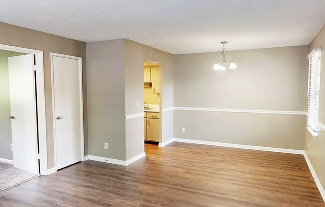 A room with wooden floors and a chandelier.