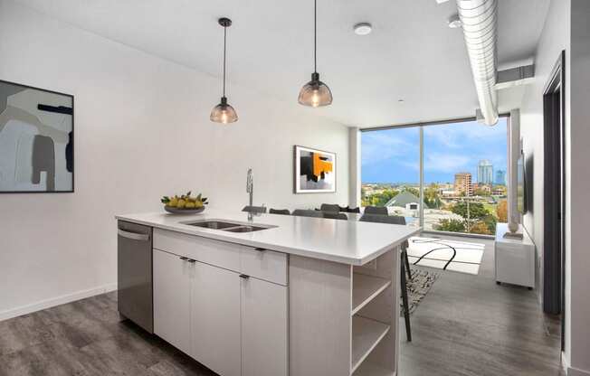 an open kitchen with an island and a view of the city