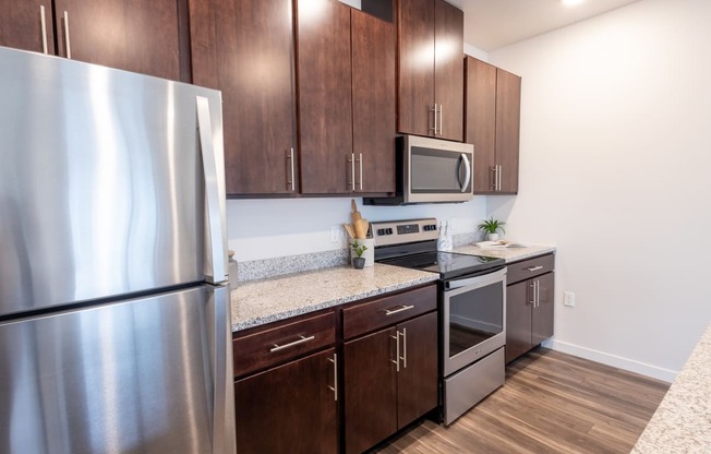 a kitchen with stainless steel appliances and wooden cabinets