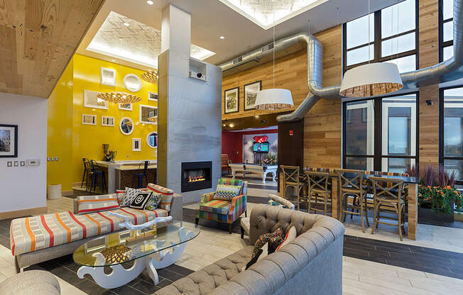 a living room with couches and chairs and a fireplace at Ann Arbor City Club, Ann Arbor, 48104