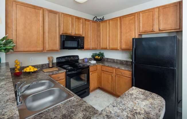 Kitchen With Sink, Refrigerator And Modern Appliances at Abberly Village Apartment Homes by HHHunt, South Carolina, 29169
