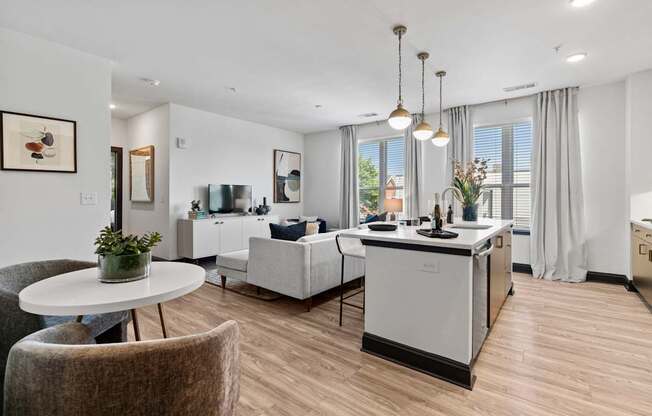 A modern kitchen with a dining table and chairs.