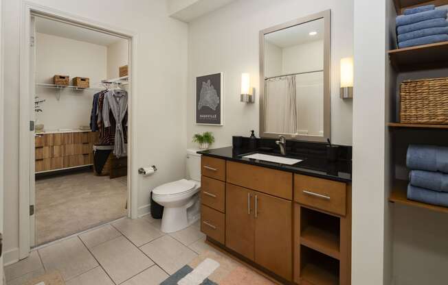 a bathroom with a toilet and a sink and a mirror