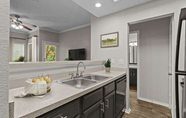 an empty kitchen with a sink and a refrigerator