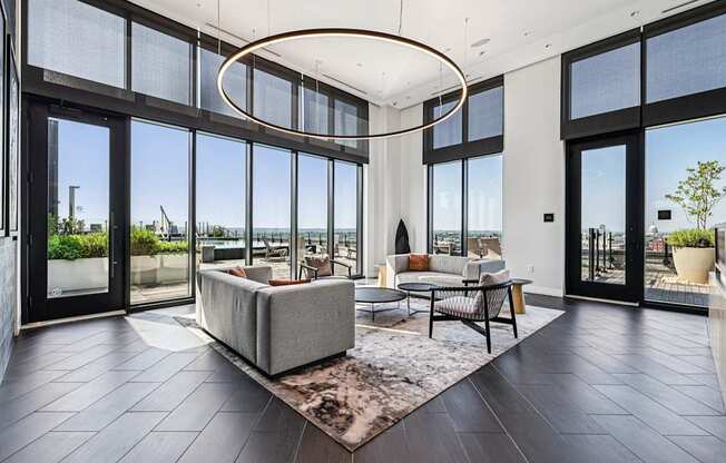 A modern living room with a large window overlooking the ocean.