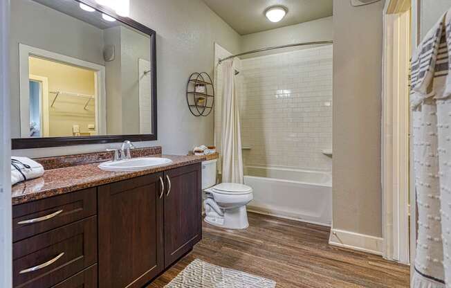 A bathroom with a toilet, sink, and shower.