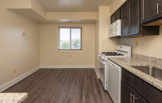 A kitchen with a stove, oven, and cabinets.