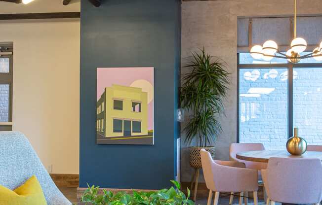 a room with a blue wall with a painting of a yellow house on it at 511 Meeting, South Carolina