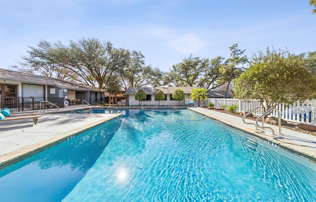 A large swimming pool with a blue tinted water.