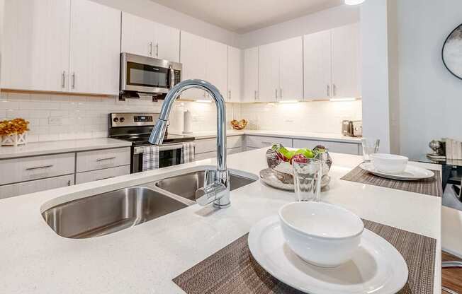 a kitchen with a sink and a counter with a bowl on it