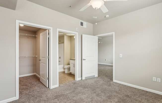 an empty bedroom with a closet and a bathroom