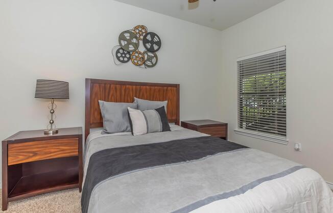 a bedroom with a bed and a chair in a room