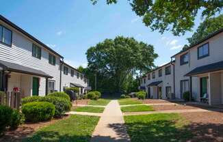 A row of houses with a pathway in the middle.
