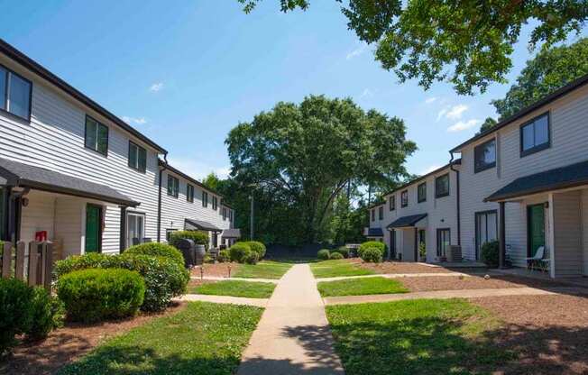 A row of houses with a pathway in the middle.