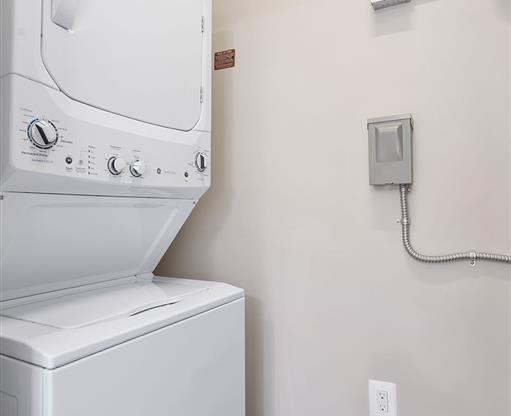 a dryer and a washing machine in a white room
