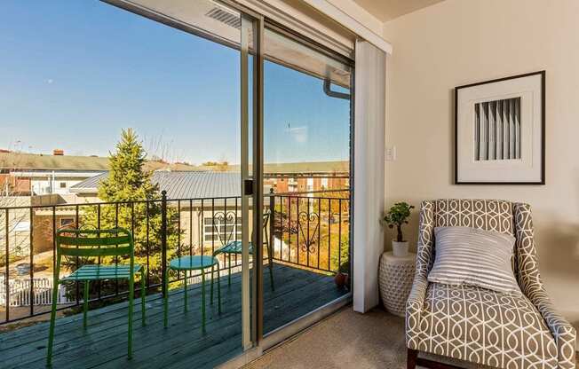 a balcony with a chair and a sliding glass door at Village Club of Royal Oak, Royal Oak, MI