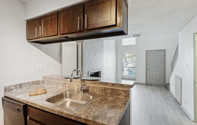 an empty kitchen with a sink and a counter top