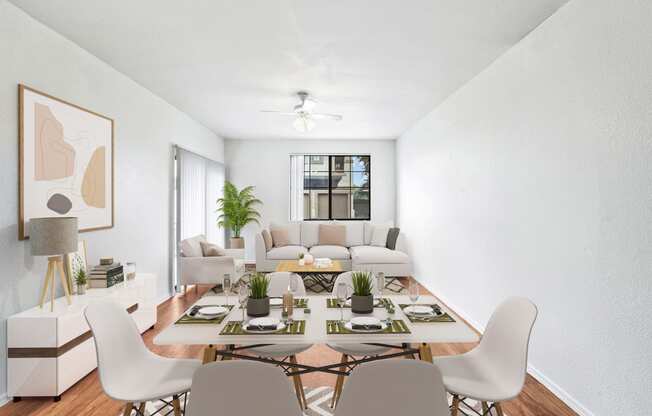 virtually staged dining and living room with hardwood-style flooring, ceiling fan, and window