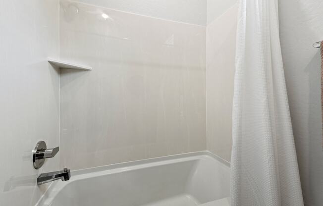 a bathroom with a tub and a shower curtain