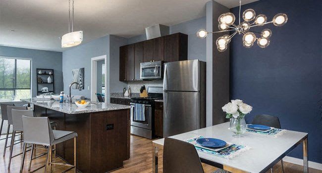 a kitchen and dining room with a table and chairs