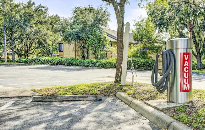 Car Vacuum Next to Parking Lot and Trees