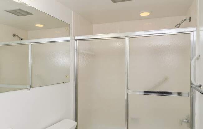 A white toilet and sink in a small bathroom.