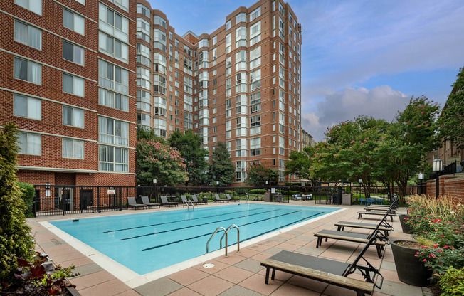 a swimming pool in front of an apartment building